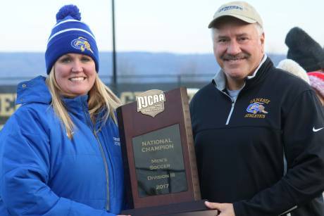 gcc_athletic_director_kristen_schuth_left_poses_with_gcc_president_dr._james_sunser_right_with_the_njcaa_national_title_plaque_for_mens_soccer_sunday.jpg