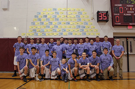 bb_boys_basketball_team_in_front_of_donation_wall.jpg