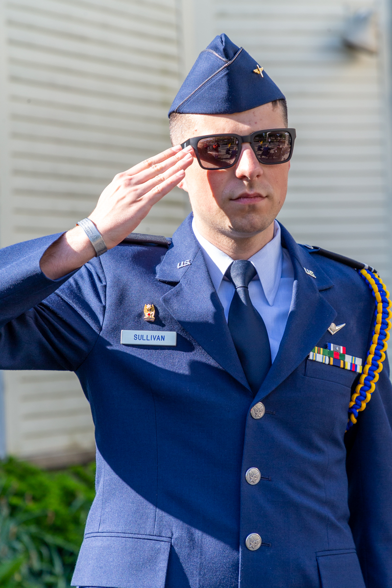 serviceman saluting the flag during the services