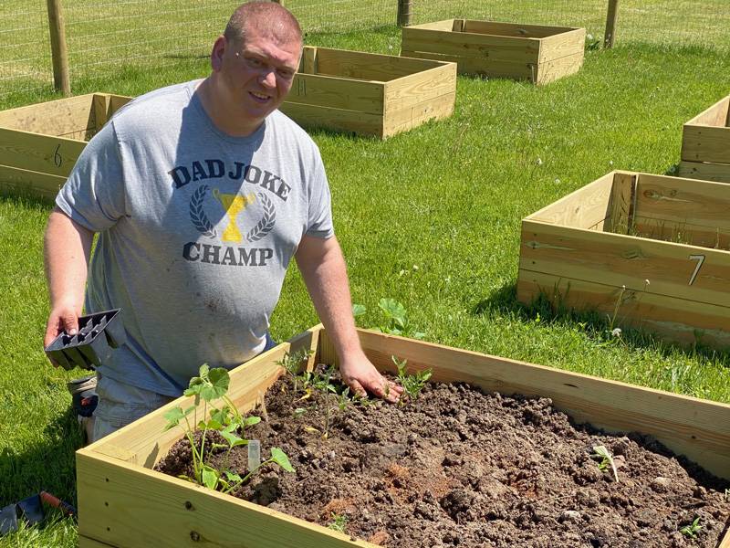 Tom tharp planting in community garden