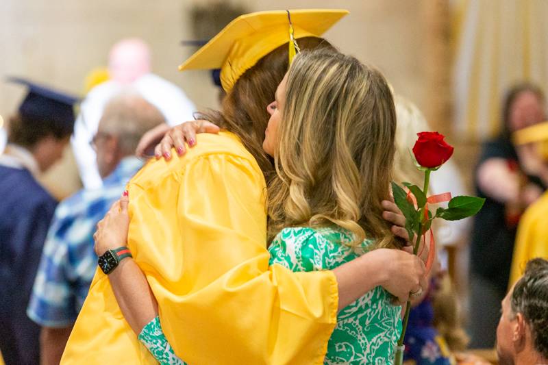 Avelin Tomidy gives her mom a hug and rose