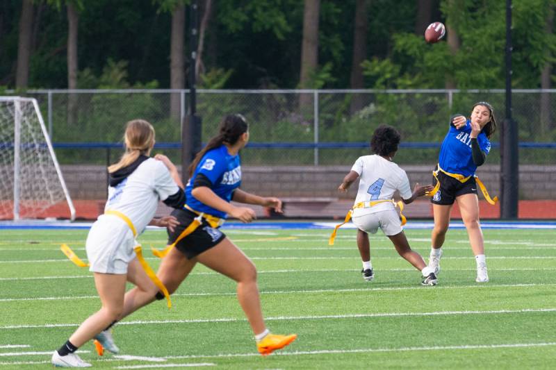 Quarterback Julia Clark making a pass to her teammate