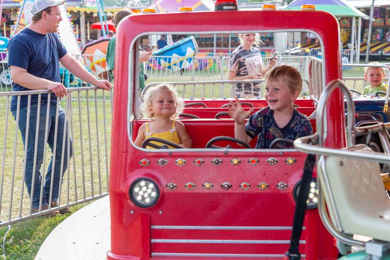 Siblings enjoy a kids ride - Photo by Steve Ognibene