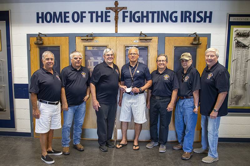 K of C members along with Grand Knight Ken Mullen present a scholarship check to Notre Dame business administrator, Thomas Rapone  Photo by Steve Ognibene