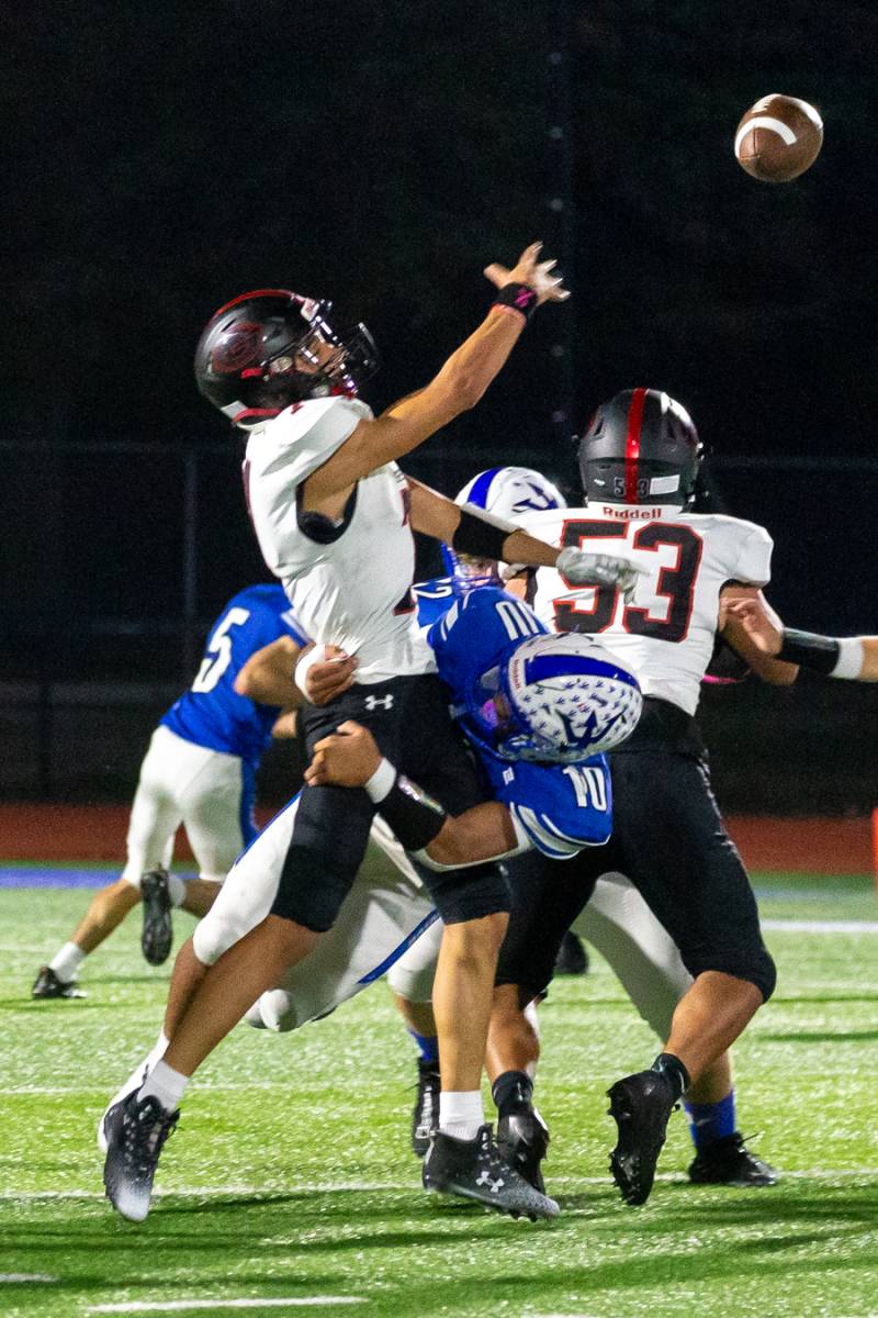 Geneva Senior quarterback Rey Dejesus feeling pressure from Batavia senior Mekhi Fortes.  Photo by Steve Ognibene