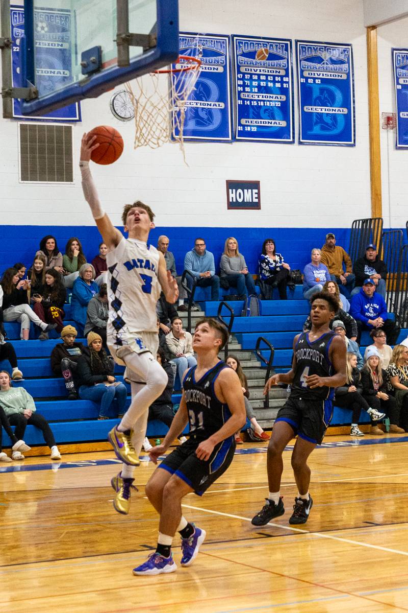 Carter Mullen gets past Brockports defenders. Photo by Steve Ognibene