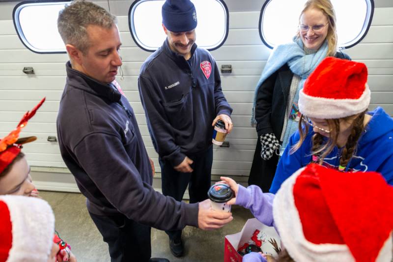 Batavia Fire Department staff receiving hot drinks. Photo by Steve Ognibene