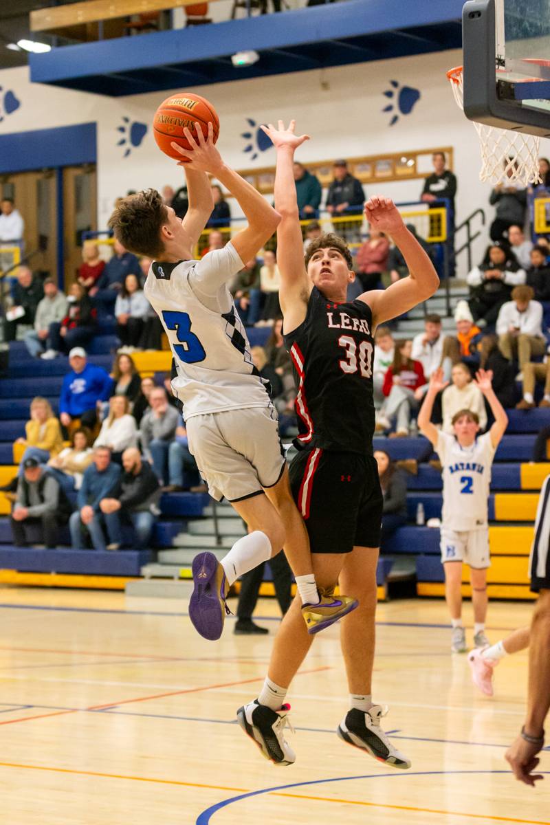 Carter Mullen driving to the hoop for two points. Photo by Steve Ognibene