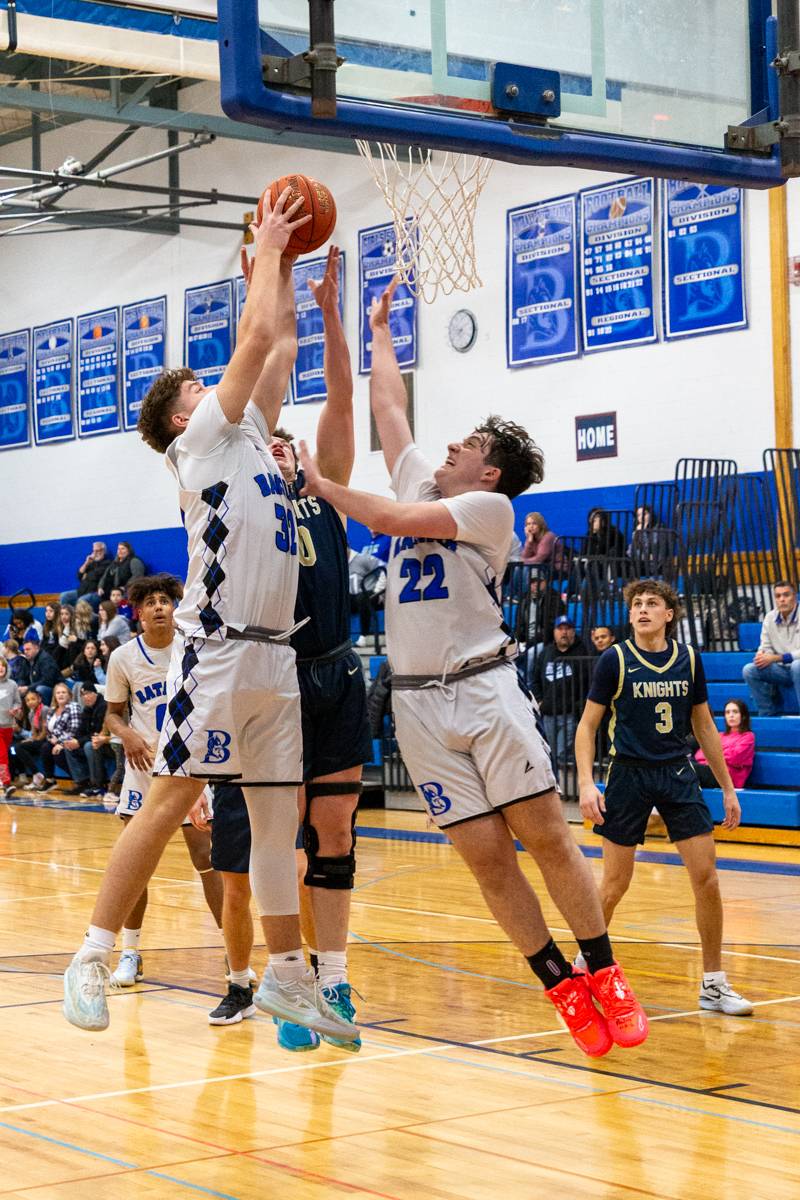 Batavia's Gavin White and Aiden Bellavia digging for rebound.  Photo by Steve Ognibene