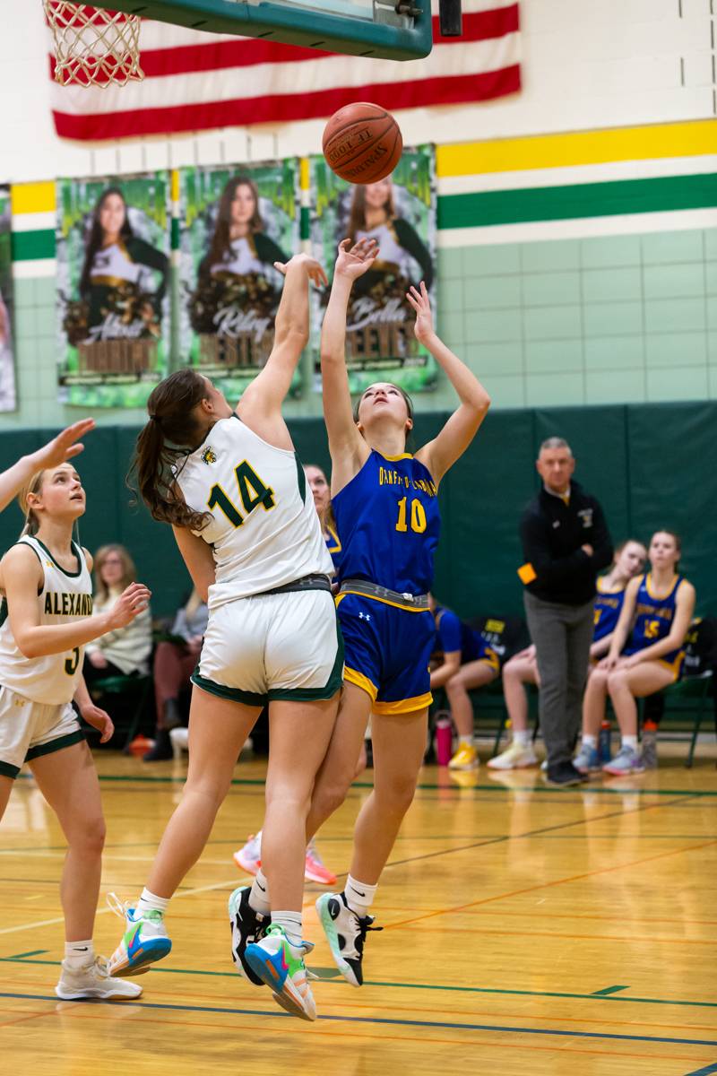 Piper Hyde trying to shoot under the hoop for two points.  Photo by Steve Ognibene