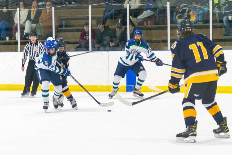 Jake Hutchins coming down the side boards with teammate.  Photo by Steve Ognibene