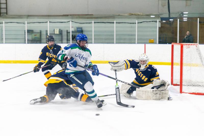 Ivan Milovidov on the doorstep of Victor's goalie.  United outshot Victor 39-32  Photo by Steve Ognibene