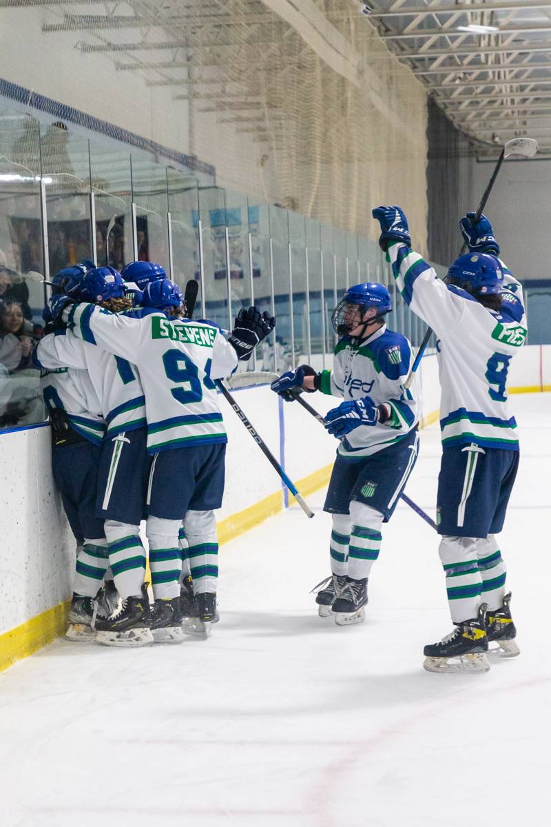 Brady Johnson and teammates celebrate his second goal of the game.  Photo by Steve Ognibene