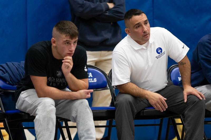 Casper Stewart and Coach Rick Stewart guiding a team member in his match.  Photo by Steve Ognibene