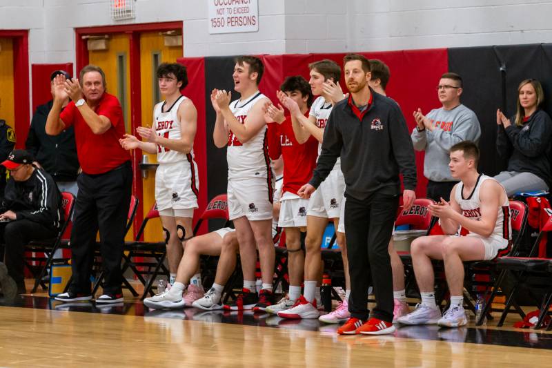 LeRoy Knights teammates stand and applaud Holly on his achievement.  Photo by Steve Ognibene