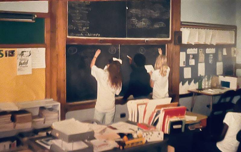 Students doing math at the blackboard