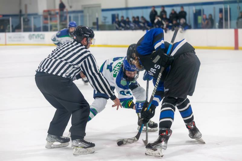 Jake Hutchins on the faceoff.  Hutchins scored a goal and an assist in United's win.  Photo by Steve Ognibene