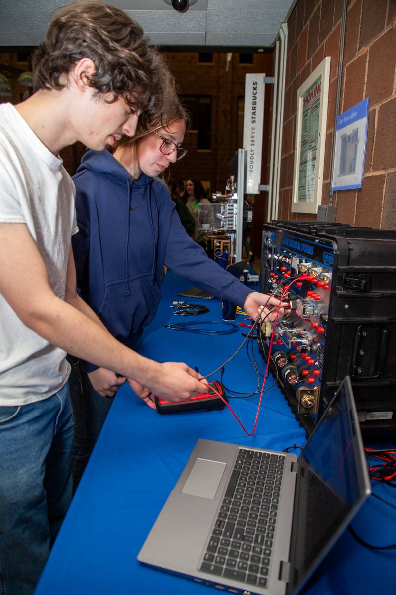 BOCES students LeRoy Kylie Paddock and Notre-Dame Matthew Rogers demostrate the ACDC system  Photo by Steve Ognibene