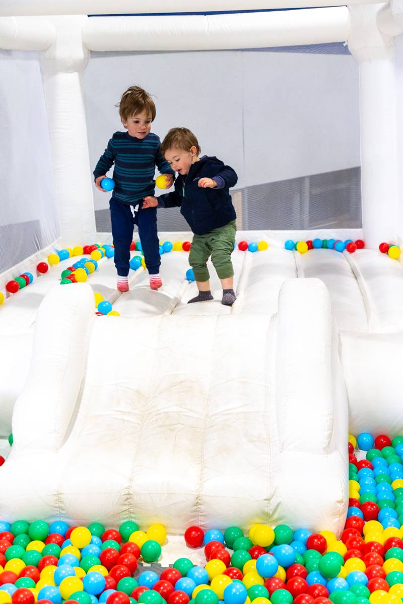 Some kids from Harrisburg, PA enjoying the bouncehouse inside the main building at the fair.  Photo by Steve Ognibene