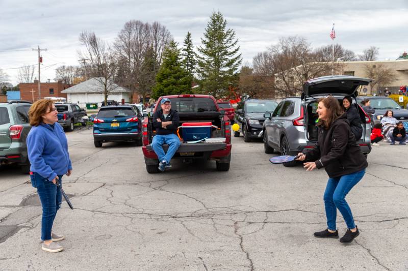 Some adults playing pickleball in the library parking lot.  Photo by Steve Ognibene