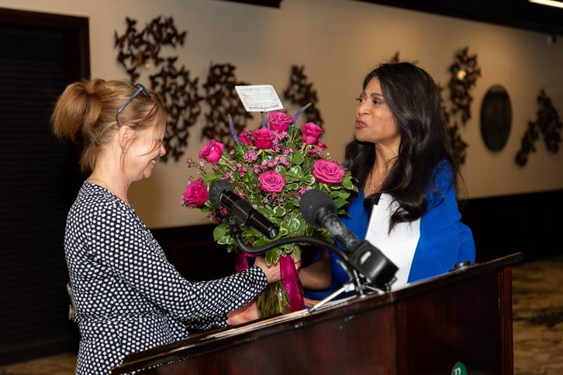 YWCA President of the board Georganne Lang presents flowers to Deanna  Photo by Steve Ognibene