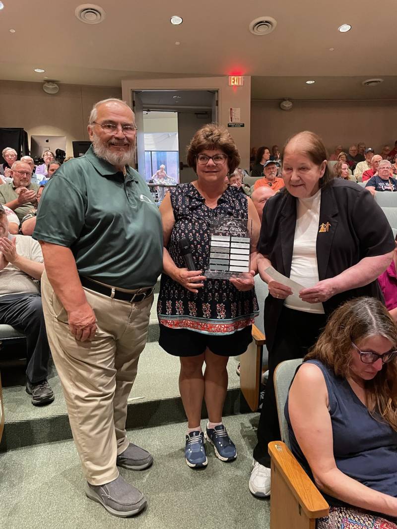 Dan Fisher, BCB Board President , Joanne Holota, BCB Board Member, Recipient of the Pam Frisby Friend of the Batavia Concert Band Award. Patti Pacino representing the Pacino Family presenting the award. Photo by Jason Smith