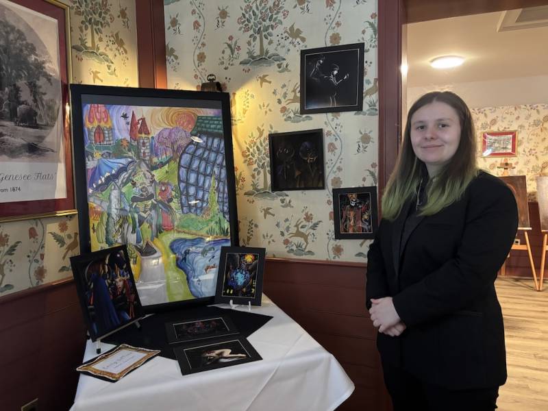 Emily Vattimo stands beside the art that she placed chronologically for the show.