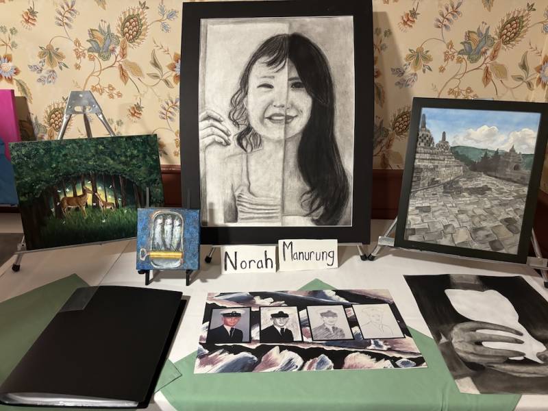 Norah Manurung's artwork shows portraits and landscapes.